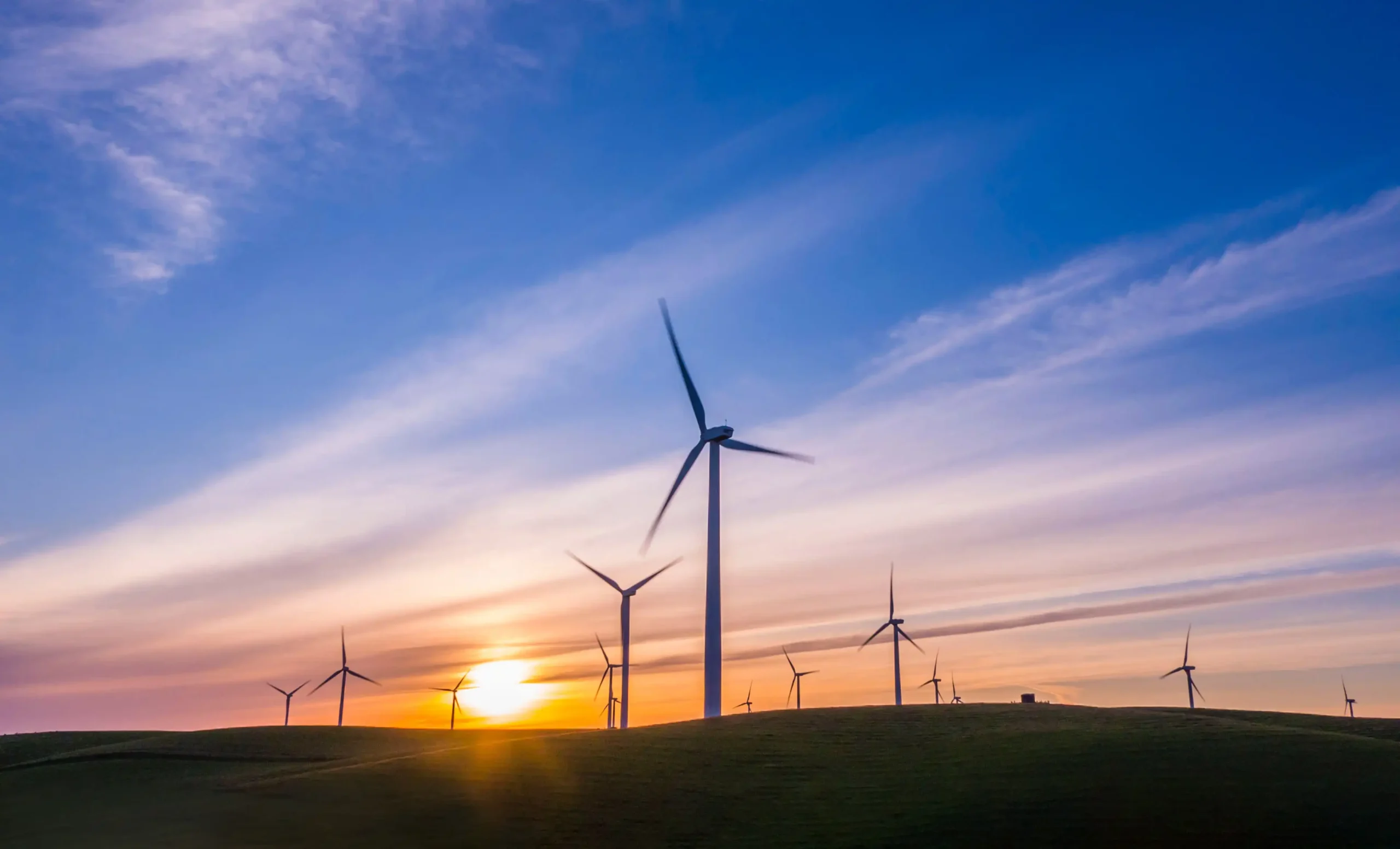 Sunset with windfarm windmill in foreground